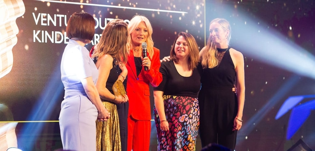 Image of teacher helping a student 